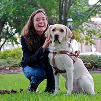 Visually impaired girl with her seeing eye dog
