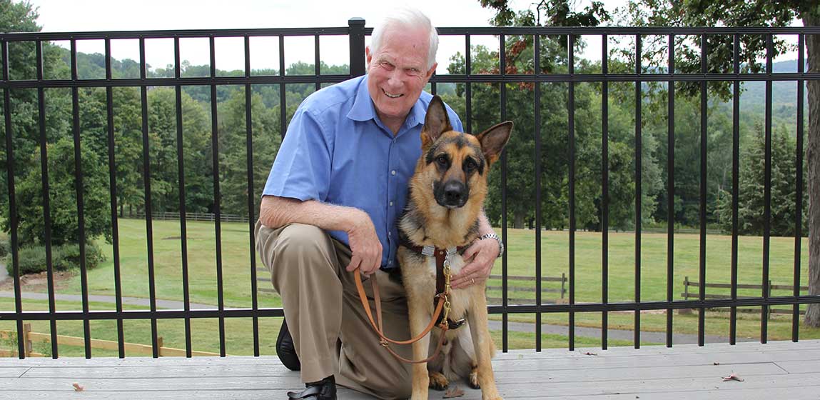 Visually impaired person with his German Shepard seeing eye dog