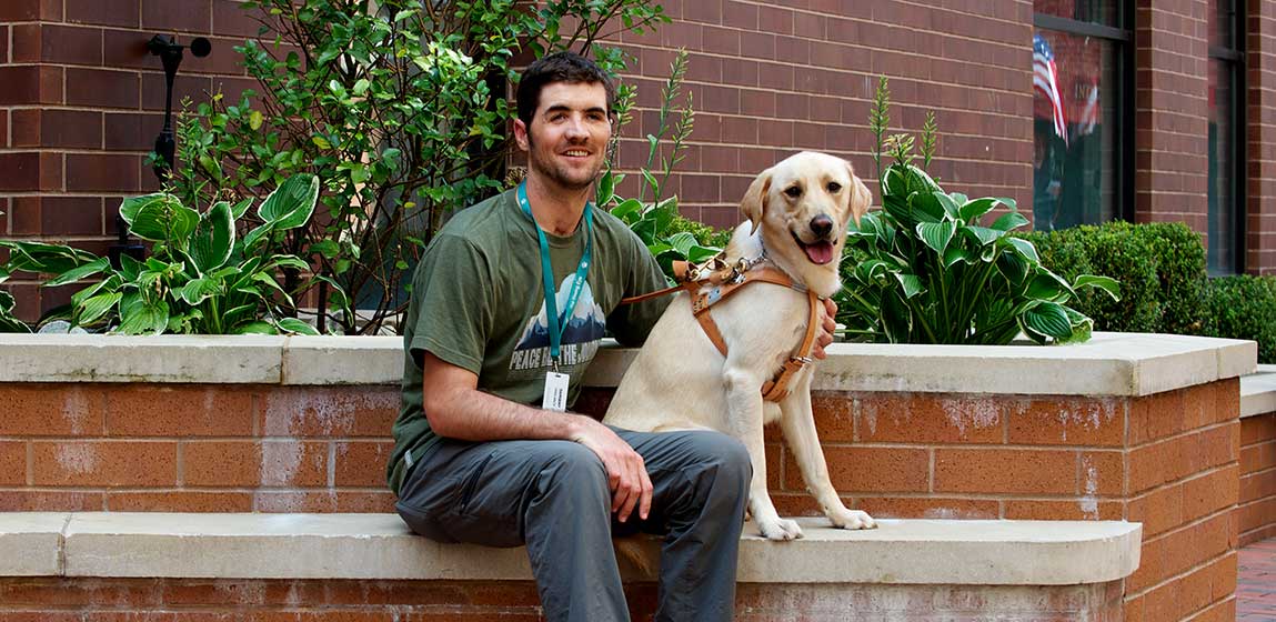 visually impaired man with his seeing eye dog