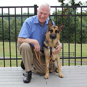 Visually impaired person with his German Shepard seeing eye dog