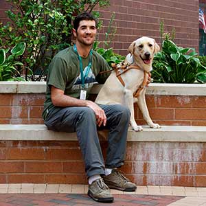 visually impaired man with his seeing eye dog