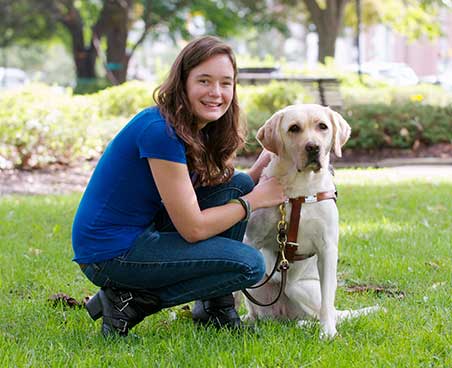 young visually impaired girl with her guide dog